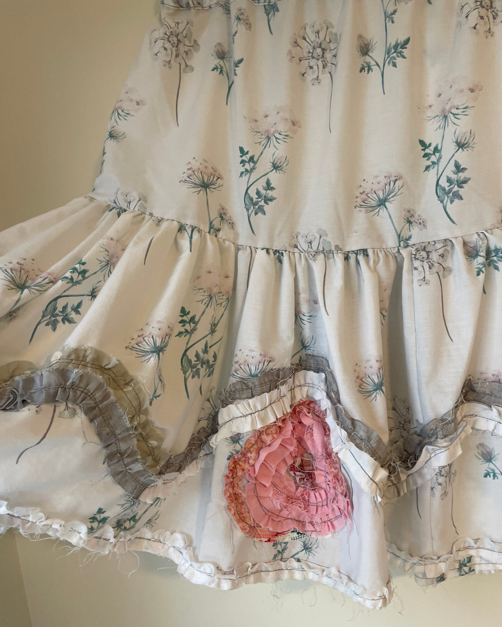 Floral patterned fabric with a pink heart design on a plain background