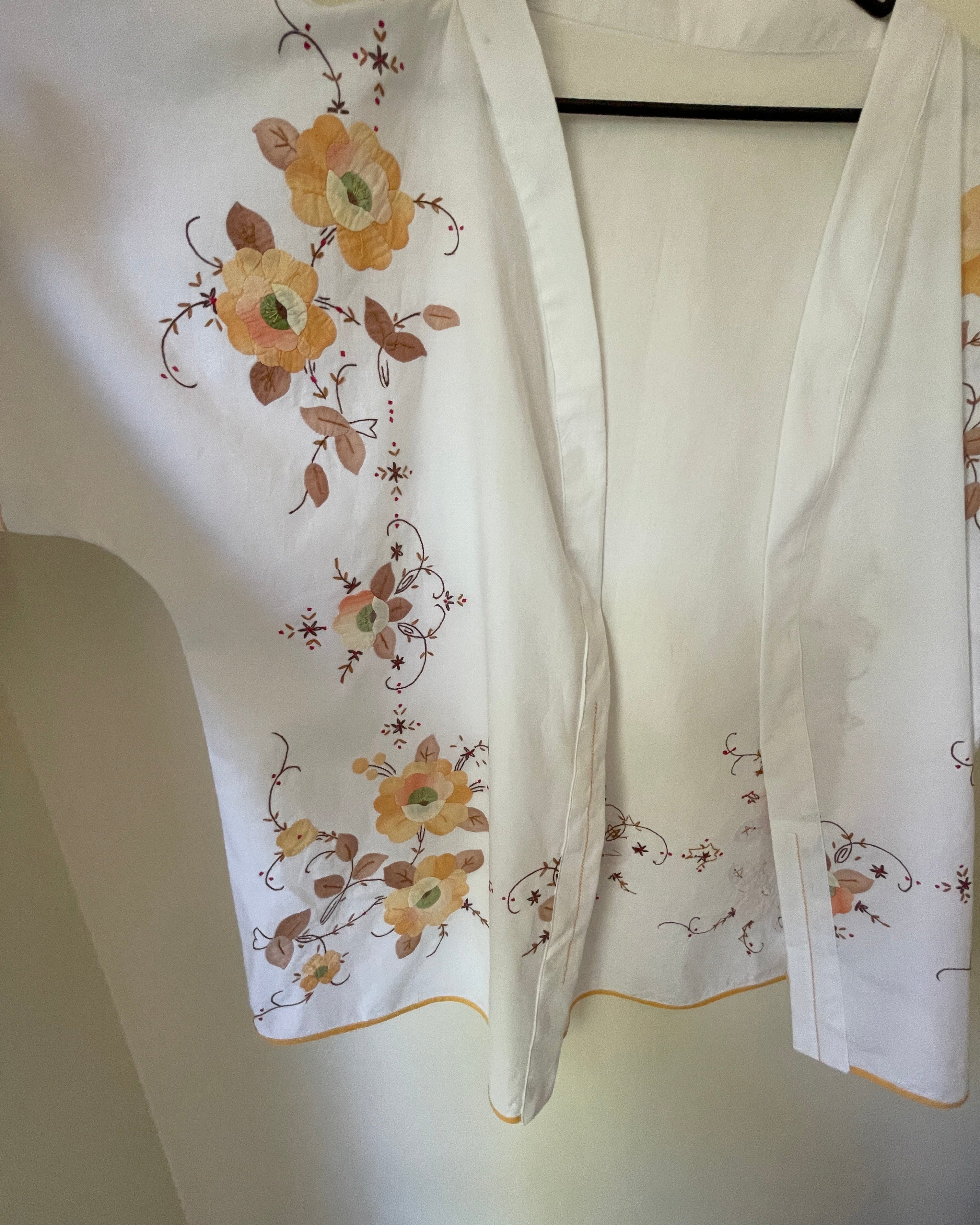 Floral embroidery on a white fabric with a neutral background