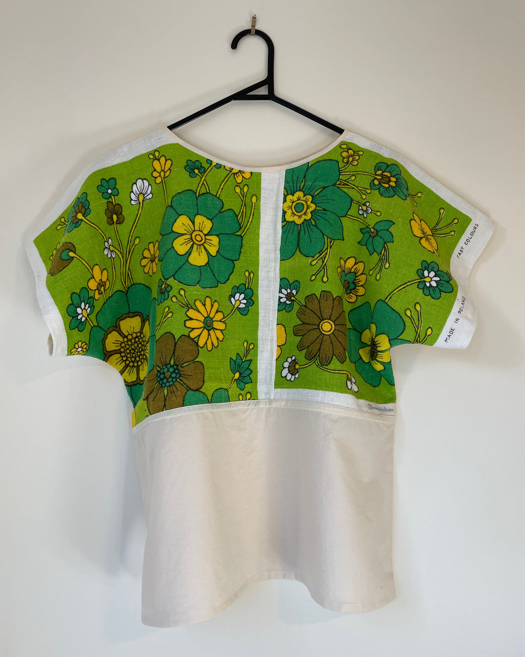 Green floral-patterned t-shirt on a white background