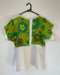 Green floral-patterned t-shirt on a white background
