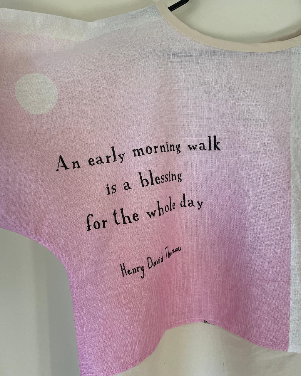 Pink fabric with a quote by Henry David Thoreau on a white background
