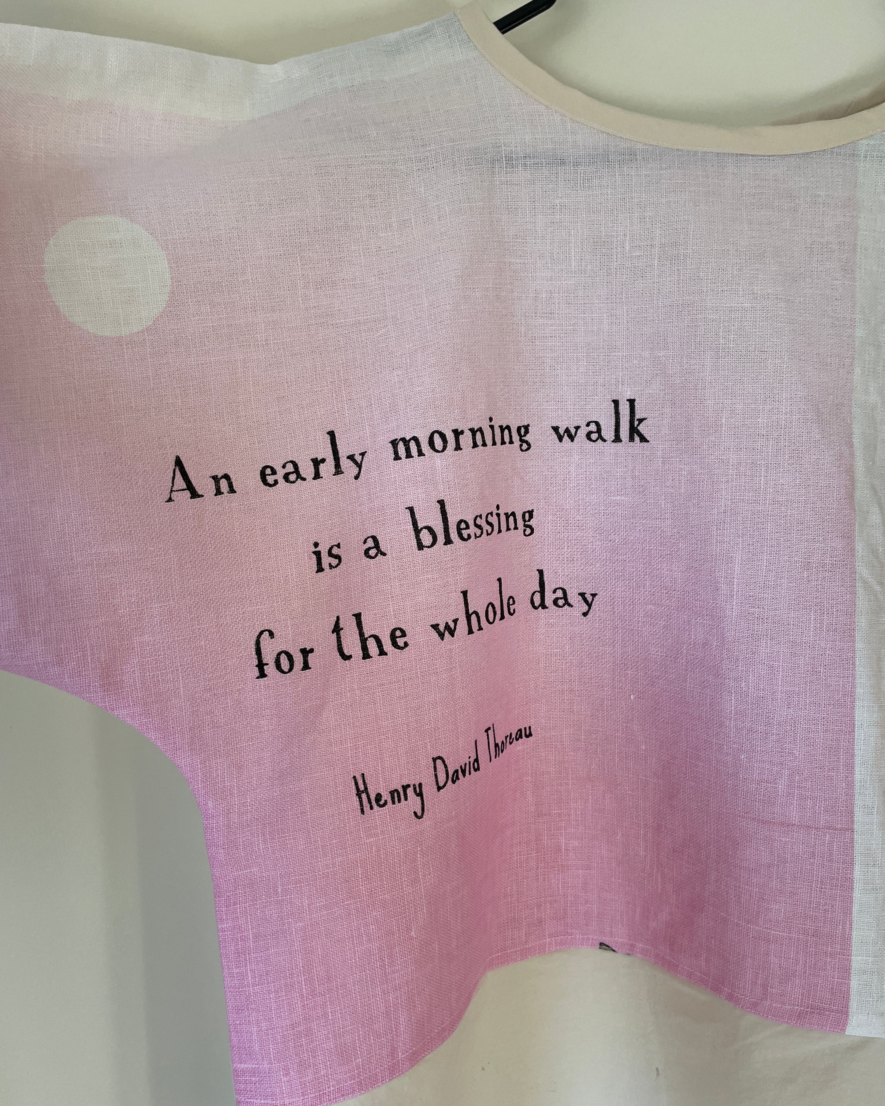 Pink fabric with a quote by Henry David Thoreau on a white background