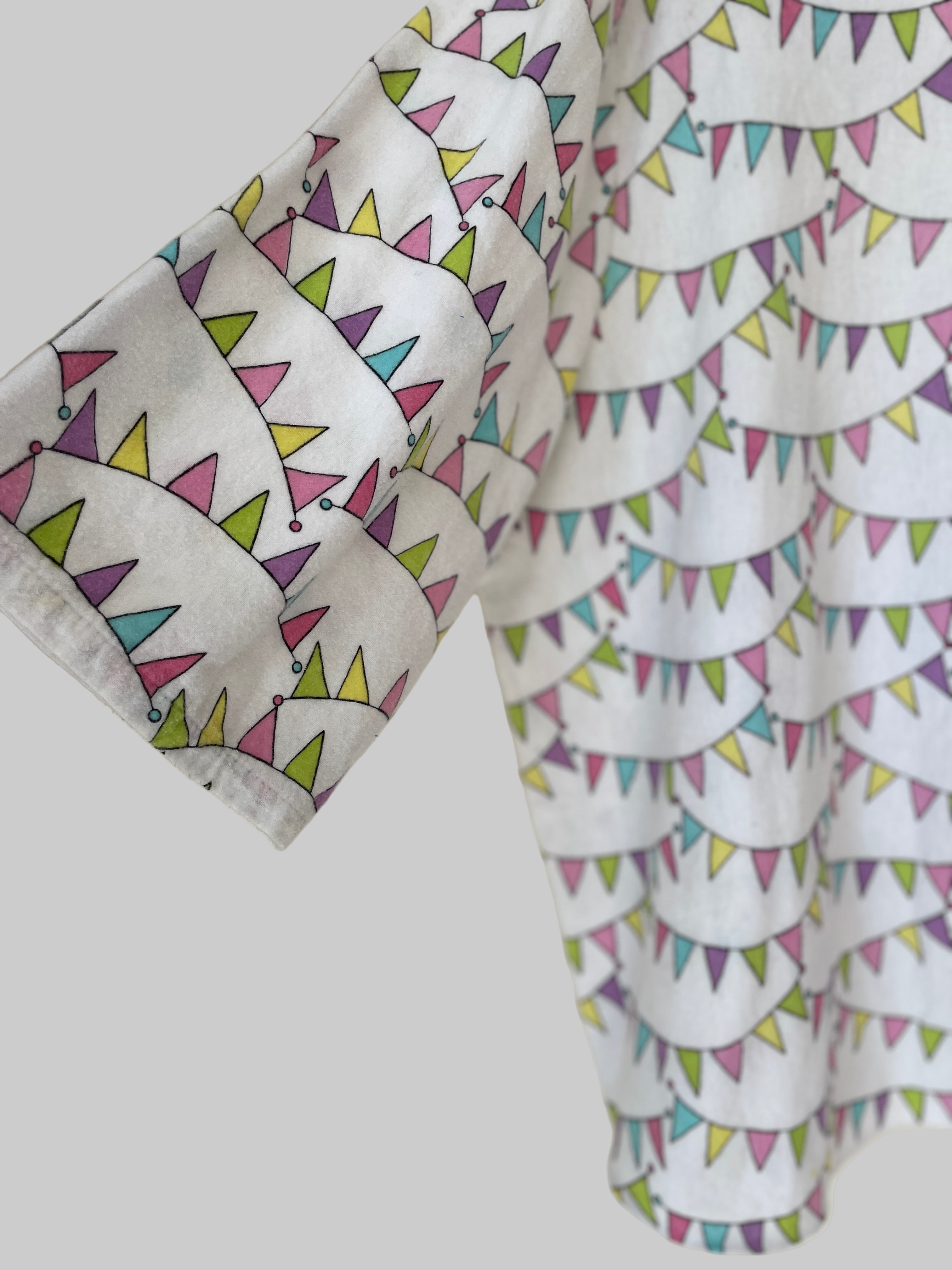 Two fabric swatches with colorful triangle and circle patterns on a white background