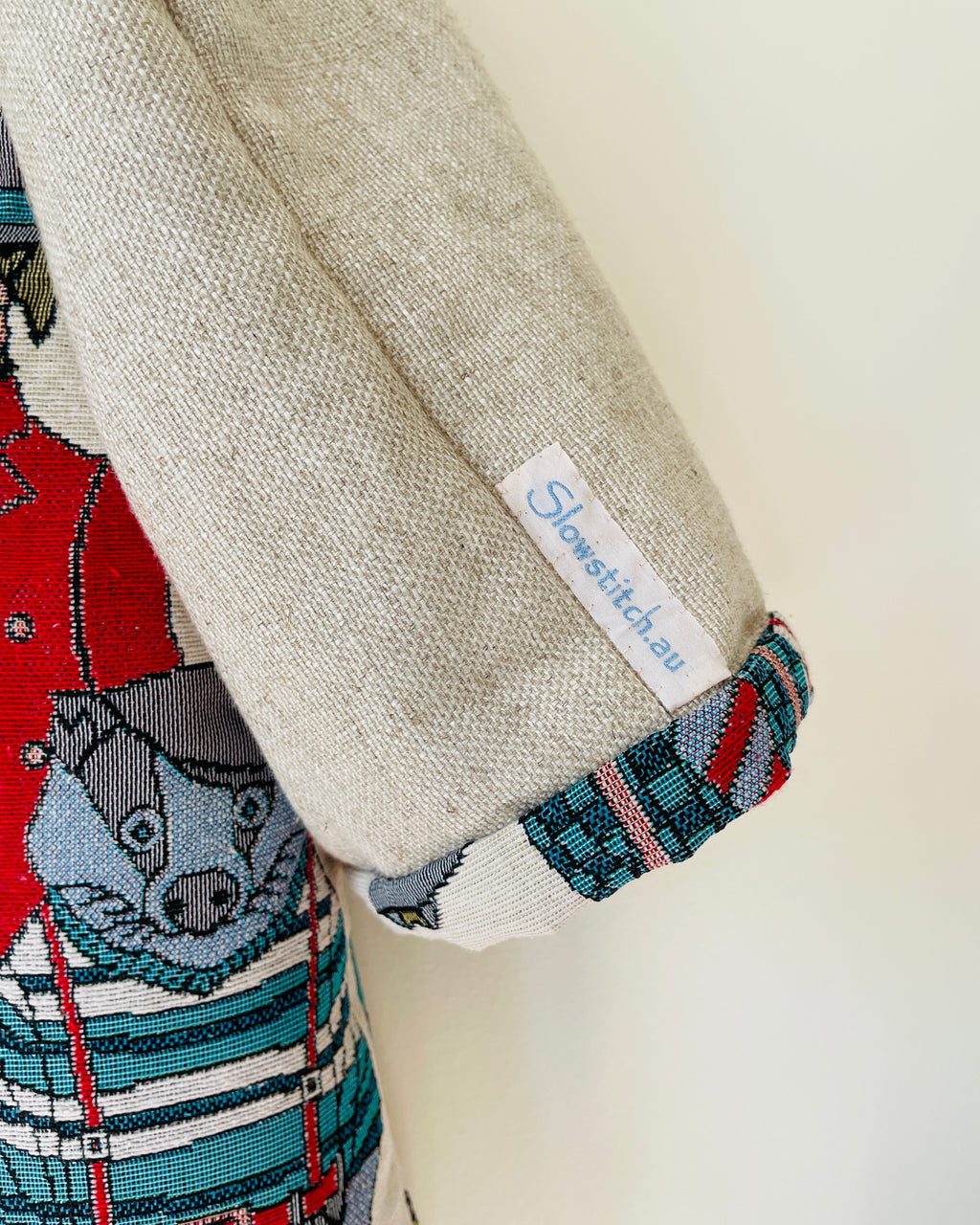 Jacket sleeve with a Slowstitch.au label on a neutral background