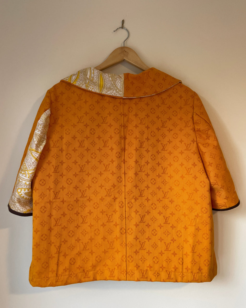 Gold patterned garment on a white background