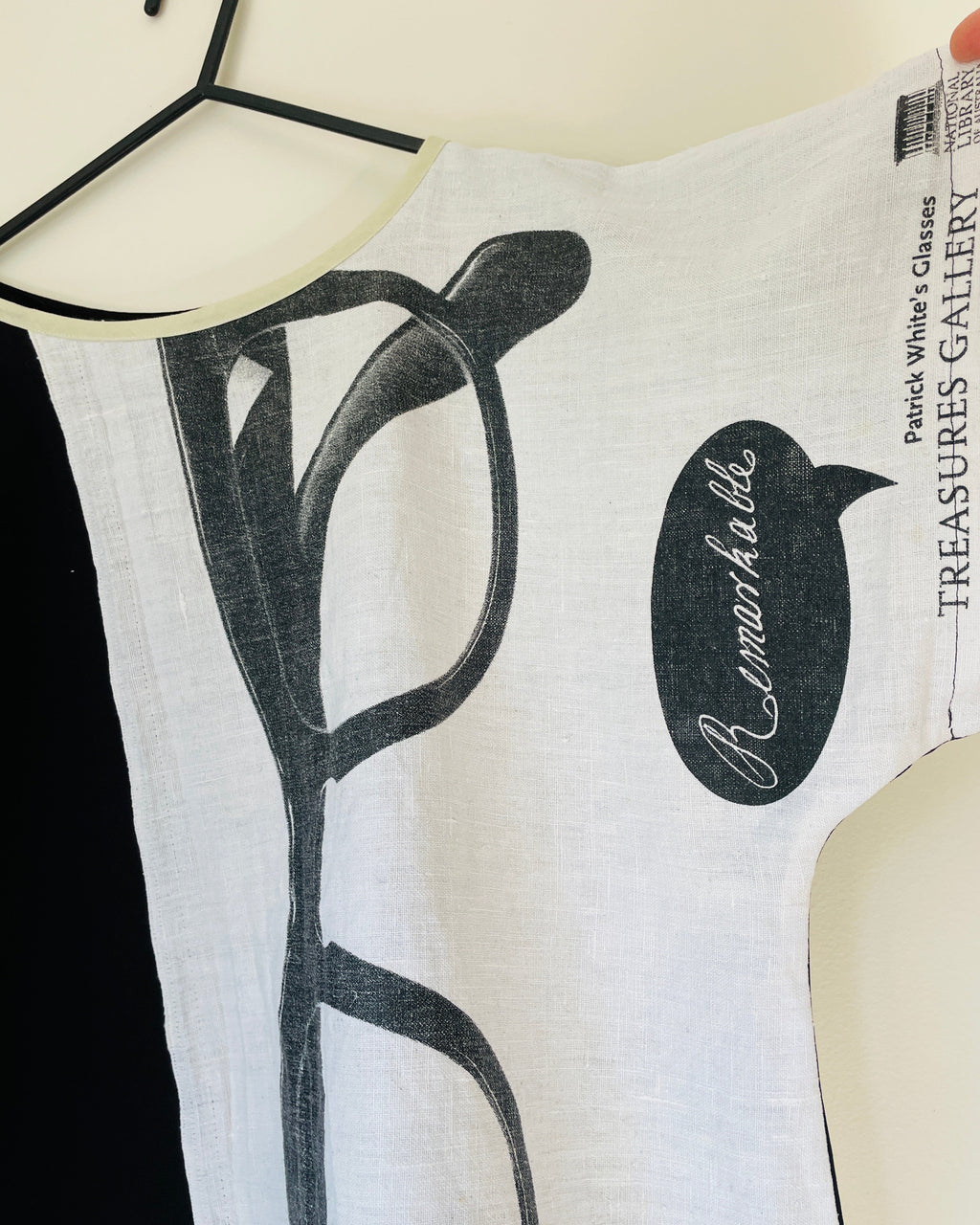White top with black graphic design and 'B. Makowsky' branding on a hanger.