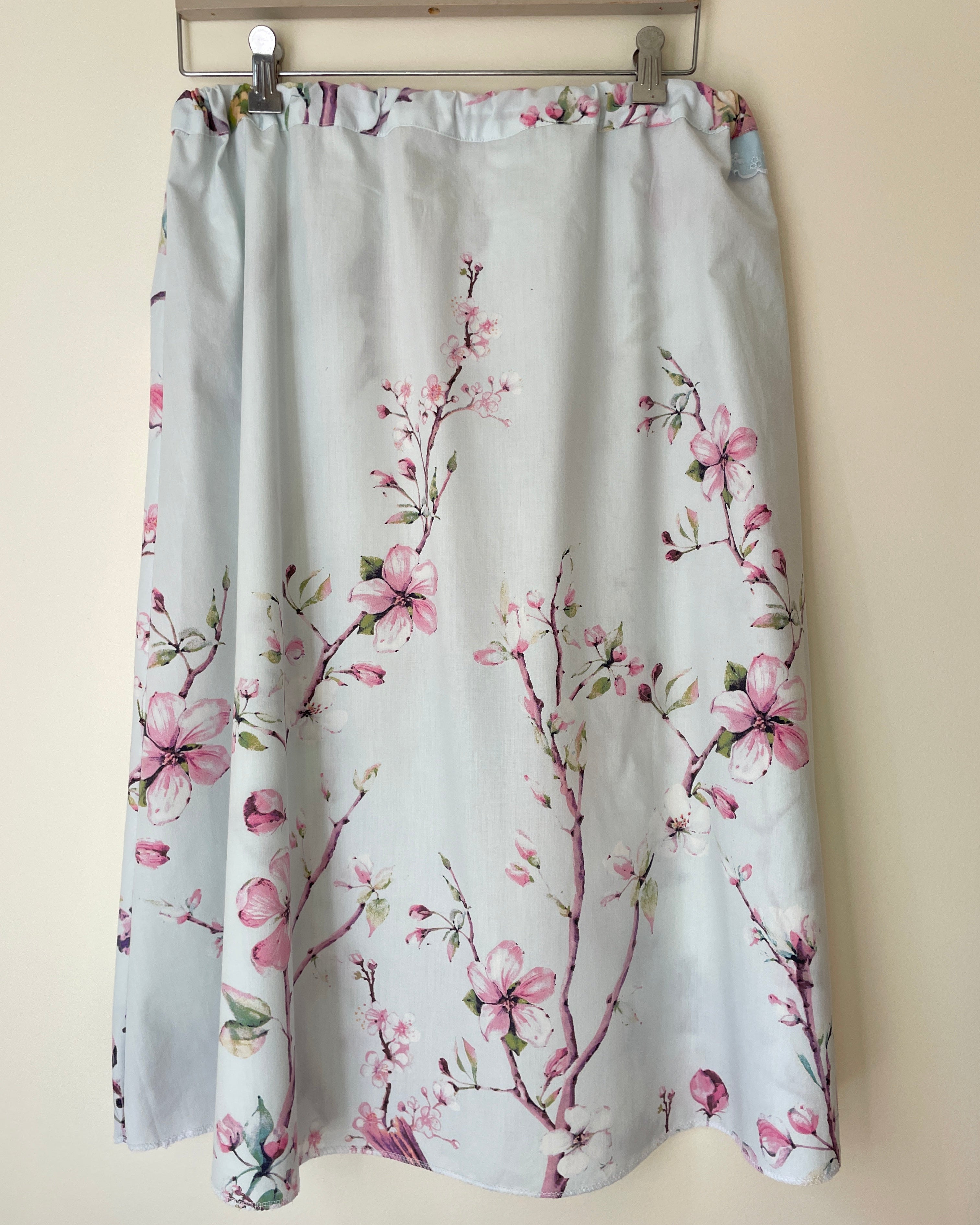 Floral patterned skirt on a beige wall