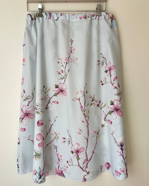 Floral patterned skirt on a beige wall