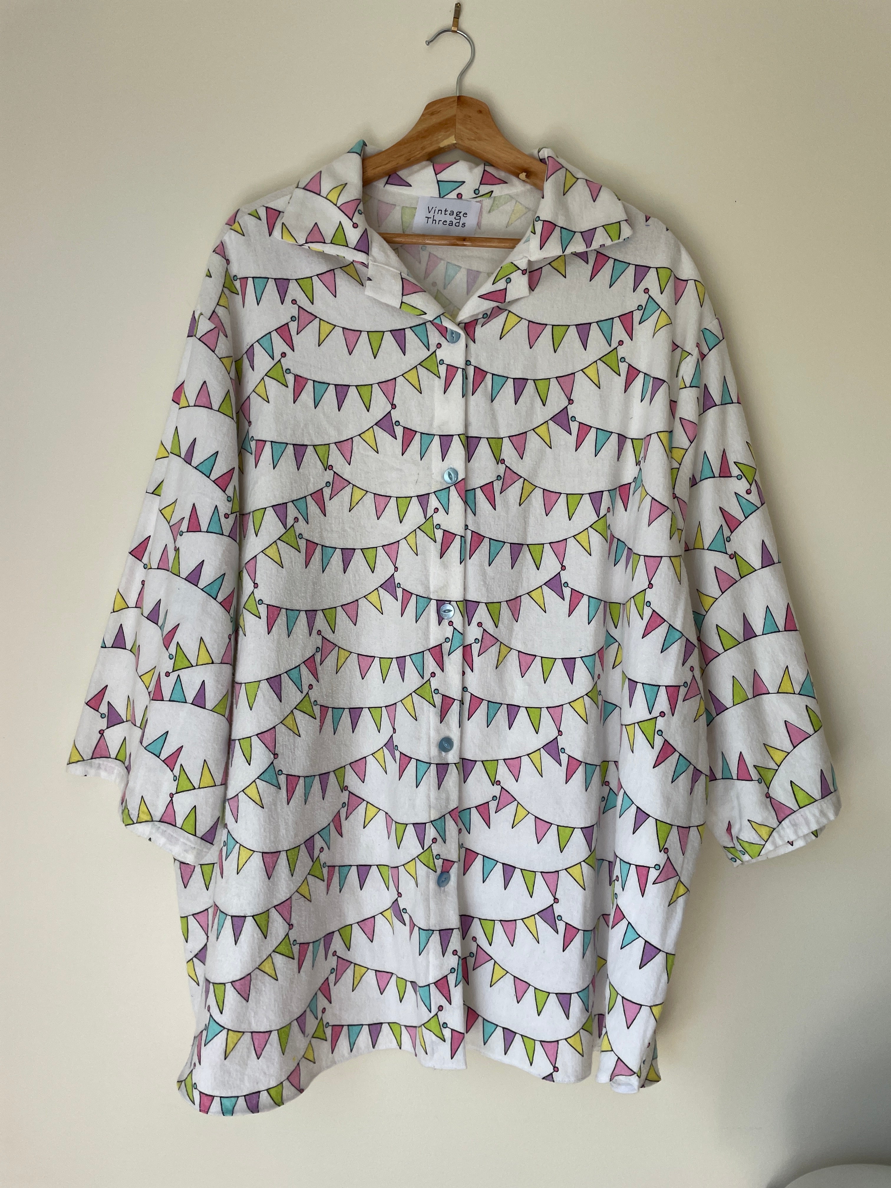 Folded shirt with colorful triangle pattern on a beige background